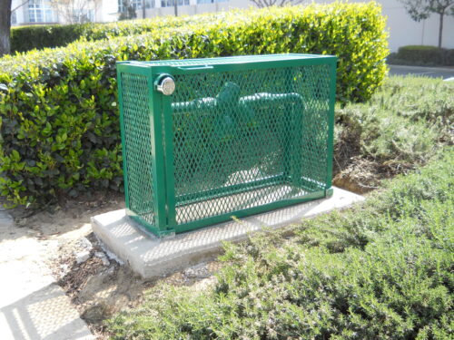 Heavy duty steel backflow cage anchored into concrete to prevent copper theft.