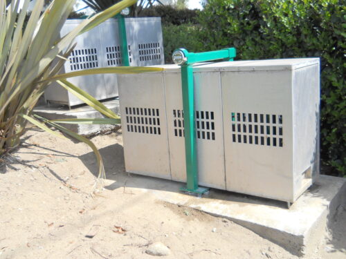 Solid steel anti-lift locking bar anchors backflow cage to concrete to prevent forced entry.